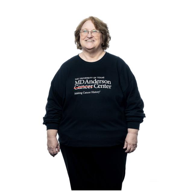 MD Anderson employee wearing black t-shirt featuring the white MD Anderson logo on the chest area.